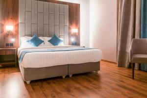 Voodi või voodid majutusasutuse Palette Luxury MAS Hotel toas