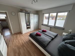 a bedroom with a bed with two red pillows on it at Fewo-H41 in Korschenbroich