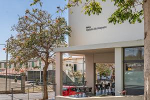a building with a tree in front of it at Amparo II by An Island Apart in Funchal