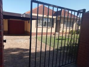 a black fence in front of a house at ATHOME BELLVILLE Chrismar in Cape Town