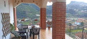 a patio with a table and chairs on a balcony at Casa IL GLICINE in Camporosso