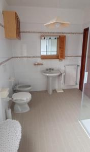 a bathroom with a sink and a toilet and a sink at Casa IL GLICINE in Camporosso +8 photos