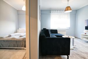 a bedroom with a bed and a couch in a room at ApartClaudia by Housine in Zator
