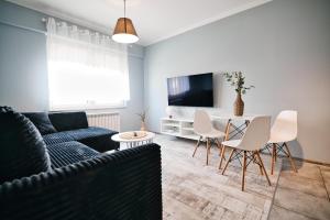 a living room with a couch and a table at ApartClaudia by Housine in Zator