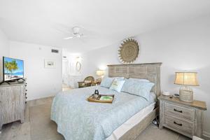 a bedroom with a bed with a tray of food on it at Coastal condo just a short walk away from the beach in Marco Island +24 photos
