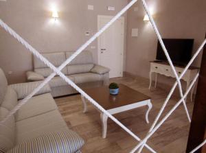 a living room with a couch and a table at Suites BELLAHELLIN in Hellín +10 photos