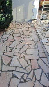 a stone walkway in front of a house at Calme Room in Mitry-Mory