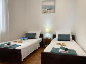 a bedroom with two beds with towels on them at Pisak holiday homes in Pisak