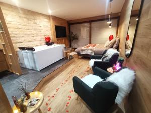a living room with a bed and a couch at L'Eden in Gréolières