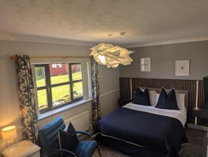 a bedroom with a bed and a window at Willowbank House and Lodges in Enniskillen