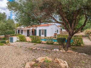 a white house with a tree in the yard at Villas Menorca Sur in Son Bou