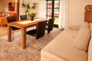 a living room with a table and a couch at Haus Oldenburg "unten" in Borkum