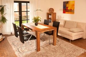 a living room with a wooden table and chairs at Haus Oldenburg "unten" in Borkum