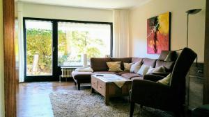 a living room with a couch and a table at Haus Oldenburg "unten" in Borkum