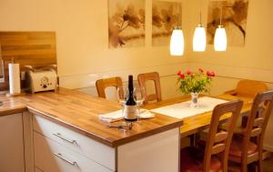 a kitchen with a table with a bottle of wine at Haus Oldenburg "unten" in Borkum +10 photos