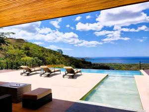 a house with a view of the ocean at Casa de Iluminacion - Gorgeous 5-BR oceanview Villa with private infinity Pool in Brasilito