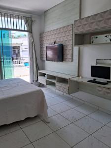 a bedroom with a bed and a flat screen tv at Casa completa Cop30 - Centro in Belém +22 photos