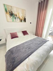 a white bed with two pillows in a bedroom at Villa Denis Ksamil in Ksamil