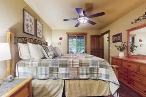 a bedroom with a bed and a ceiling fan at Fireside Escape at Lake Cushman in Hoodsport