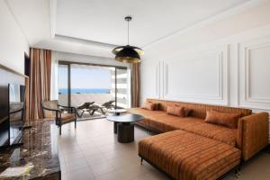 a living room with a couch and a table at Hotel Riu Palace Tikida Agadir - All Inclusive in Agadir