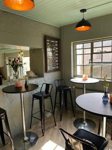 a room with tables and chairs in a restaurant at Smugglers Hotel in Brixham +9 photos