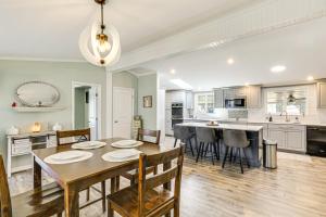 a dining room and kitchen with a table and chairs at Lake Moultrie Access Moncks Corner Home with Dock in Moncks Corner