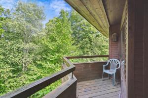 a wooden porch with a chair sitting on it at Highridge J5B Spectacular 1 Bedroom Escape with fireplace, sauna & resort amenities in Killington