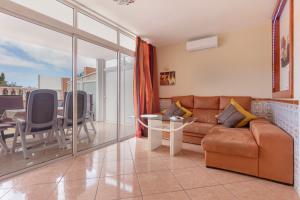 a living room with a couch and a table at Casa Marron in Costa Calma