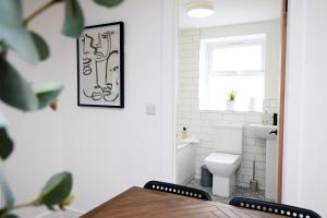 a bathroom with a toilet and a sink at Treorchy Terrace Grand Villa In Stunning Rhondda Valley By StayStaycations in Treorky +27 photos