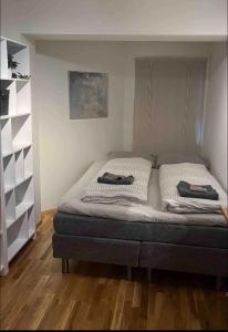 a bedroom with a bed with two towels on it at Nice appartment in Bergens best location in Bergen