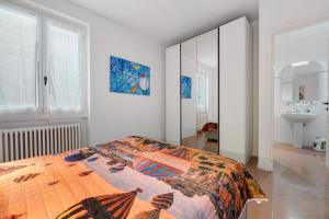 a bedroom with a bed and a bathroom with a sink at Domaso front lake in Domaso