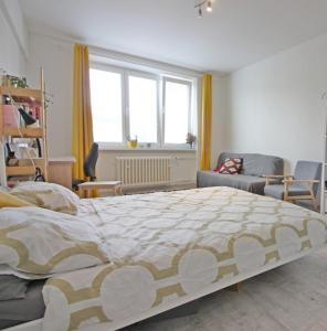 a bedroom with a large bed and a living room at UB private room in Bratislava in Bratislava