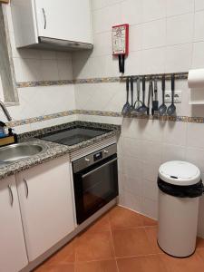 a small kitchen with a sink and a stove at Condominio do Mar in Lagos