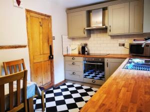 a kitchen with a table and a counter top at Valentine Cottage, Aylsham in Aylsham