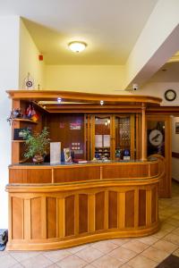 a bar in a restaurant with a counter at Hotel Corvinus in Zalaszentgrót