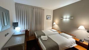 Postel nebo postele na pokoji v ubytování Hotel Centrale Resana Eli caffe