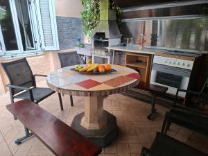 a table with a bowl of fruit on it in a kitchen at Idila in Izola +19 photos