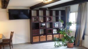 a living room with a wall unit with a flat screen tv at amazing historical appartment in Sendenhorst