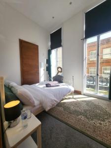 a bedroom with a bed and a large window at Imperial House "Serviced Apartments" in Margate