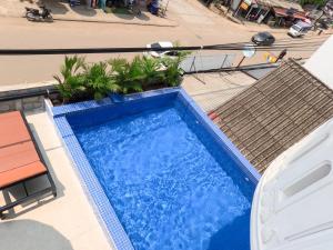 an overhead view of a blue swimming pool at Vang Vieng Rivercube Hotel in Vang Vieng