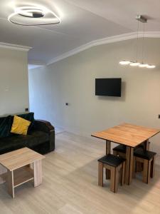 a living room with a couch and a table at Armen’s Apartment in Yerevan