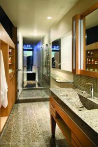 a bathroom with a walk in shower and a sink at Sparkling Hill Resort and Spa - Adults-Only Resort in Vernon