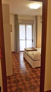 A bed or beds in a room at Casa Stazione Magliana