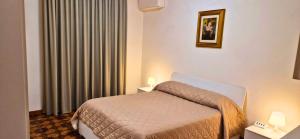 A bed or beds in a room at Casa Stazione Magliana