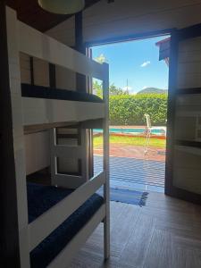 a bunk bed in a room with a large window at Casa Raízes - Atibaia in Atibaia +51 photos