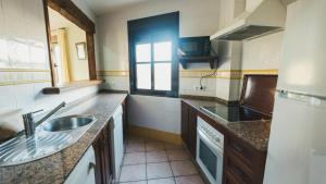 a small kitchen with a sink and a window at Apartamento El Molino by Fontanilla Del Mar Holidays Rentals in Conil de la Frontera