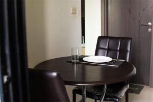 a black table with two chairs and a plate on it at The Park at West Luxury Condo in Bangkok