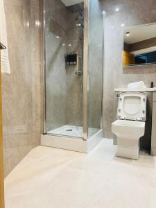a bathroom with a shower and a toilet at Thomas Arms Hotel in Llanelli +106 photos