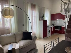 a living room with a couch and a kitchen at Kastelorizo suites in Meyisti