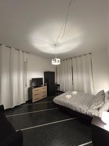 a bedroom with a bed and a tv in it at A un passo da in Genova